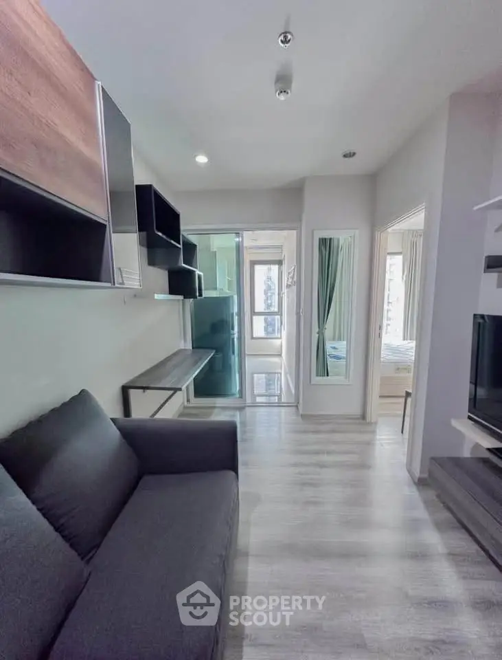 Modern living room with sleek design and cozy ambiance in a stylish apartment.