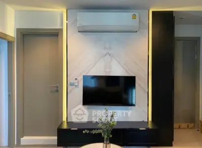 Modern living room with sleek TV setup and air conditioning
