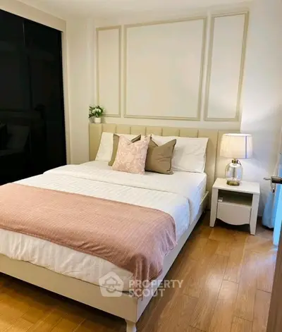 Cozy and elegant bedroom with stylish decor and wooden flooring, perfect for relaxation.