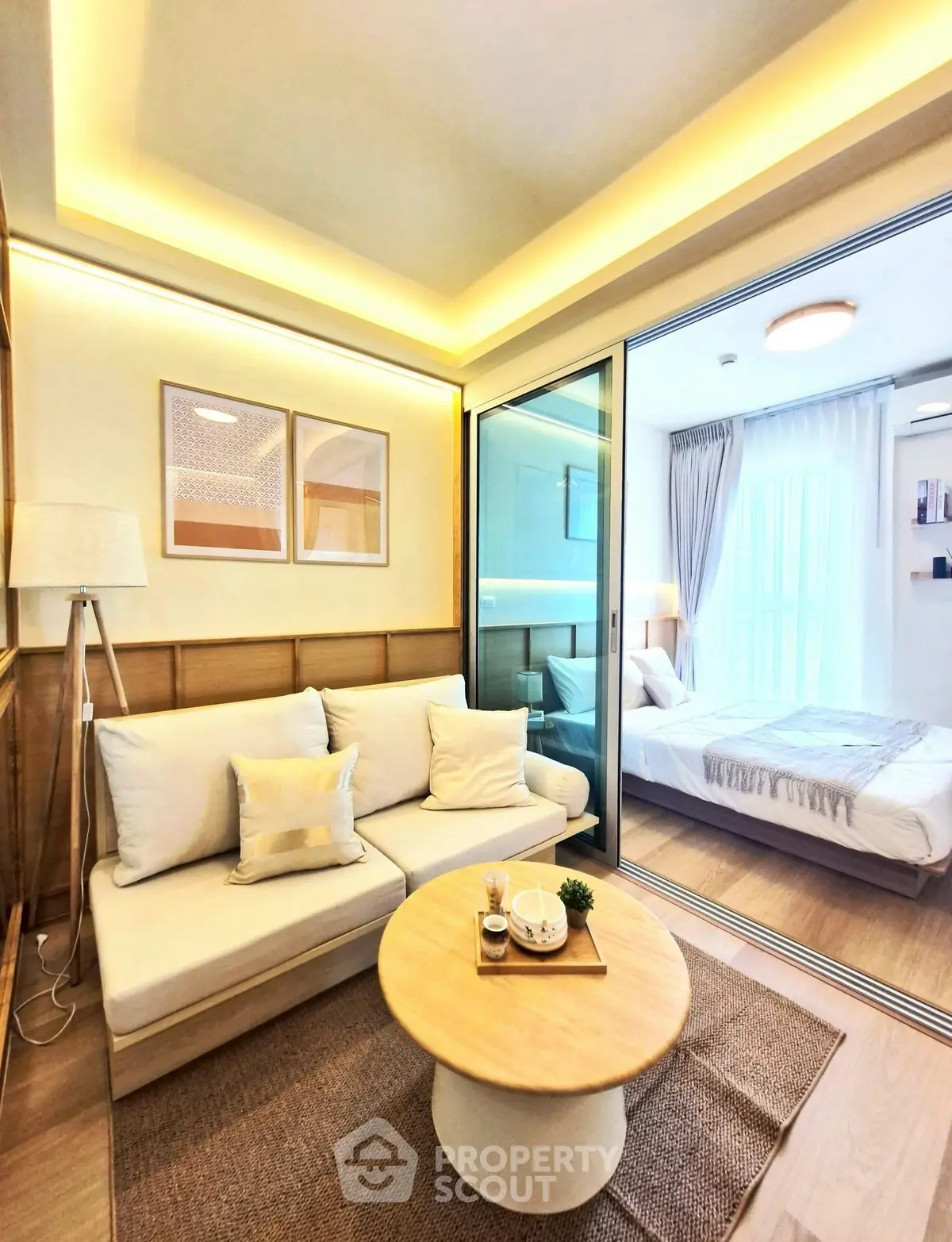 Modern living room with cozy sofa and stylish bedroom view