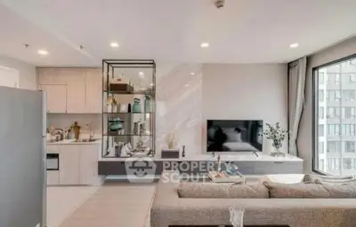 Modern open-plan living room with stylish decor and large window view.