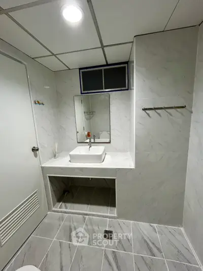 Modern bathroom with marble tiles and sleek sink design