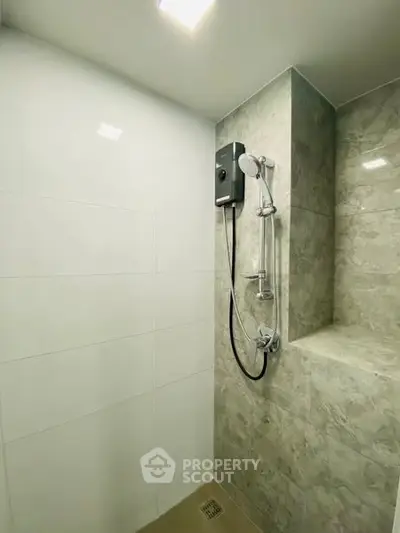 Modern bathroom with sleek shower design and elegant tile finish.