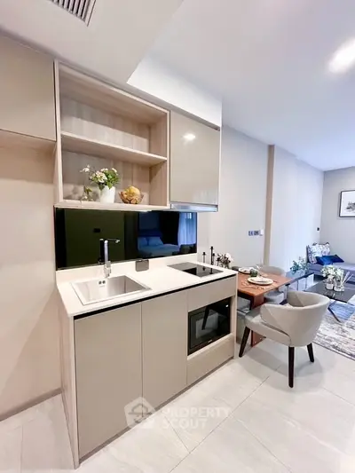 Modern open kitchen with sleek cabinetry and integrated appliances in a stylish apartment.