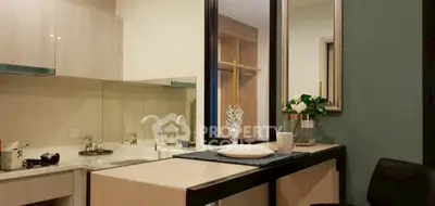 Modern kitchen with sleek design, featuring a gas stove and stylish decor, perfect for culinary enthusiasts.