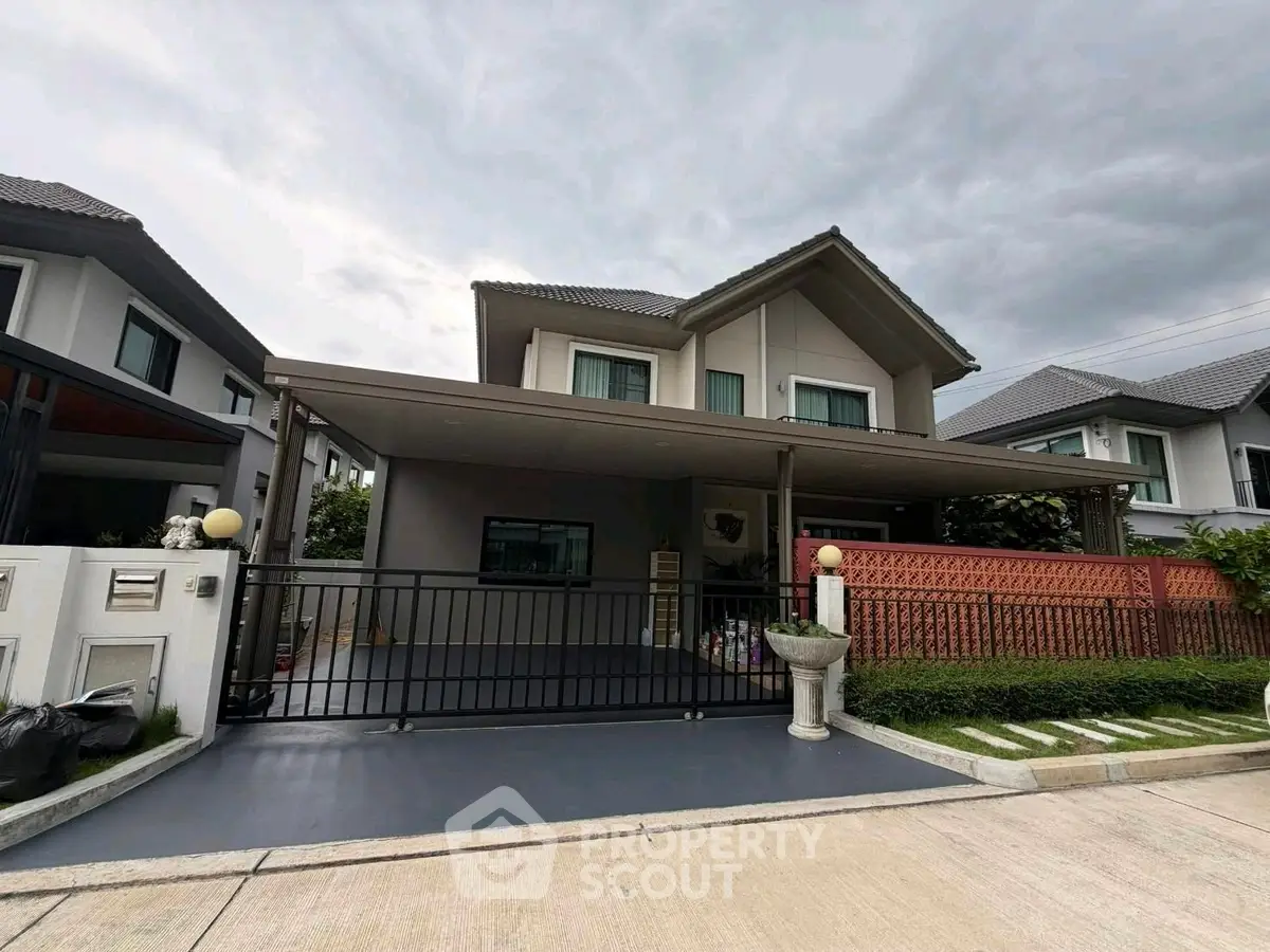 Modern two-story house with spacious driveway and landscaped front yard in a suburban neighborhood.