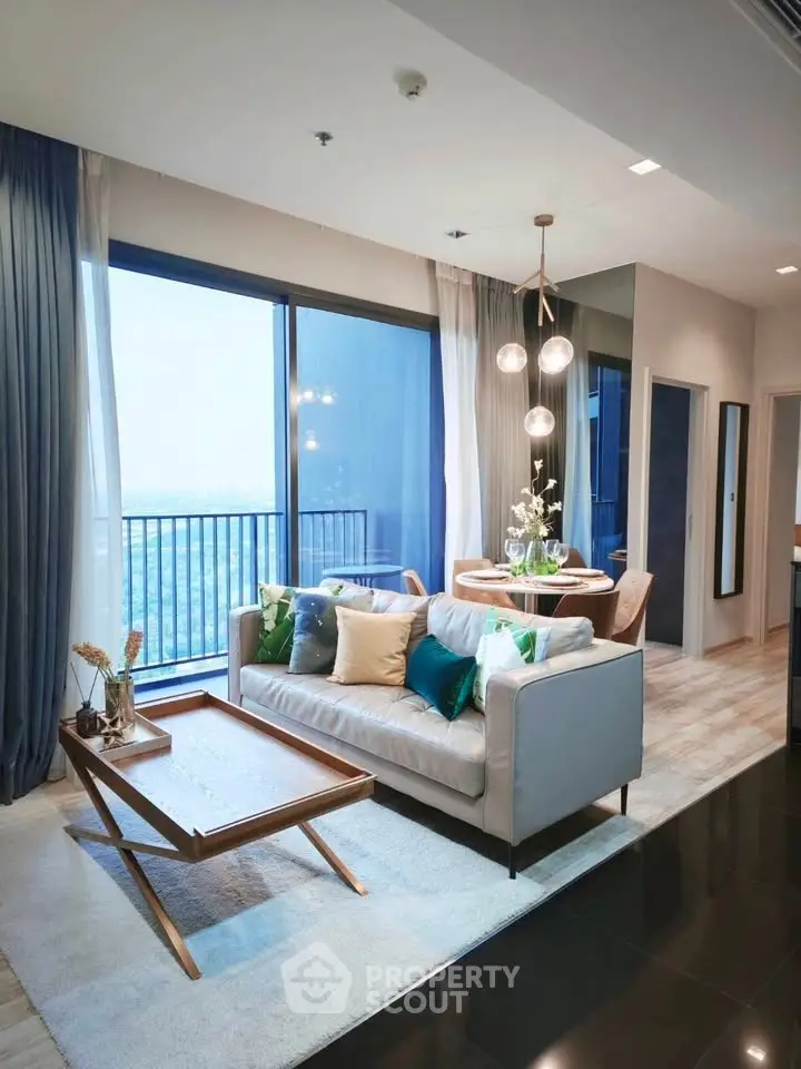 Modern living room with elegant decor and stunning city view from large windows.