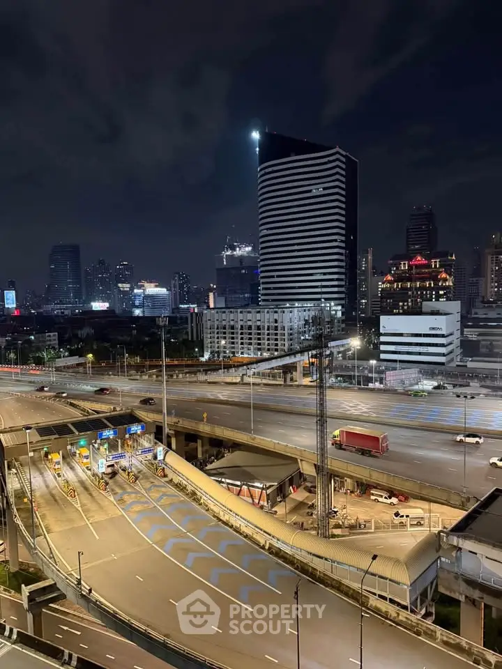 Stunning night view of cityscape with illuminated skyscrapers and highway, perfect for urban living enthusiasts.