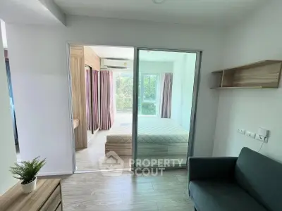 Modern bedroom with glass sliding doors and natural light, featuring a cozy bed and stylish decor.