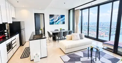 Luxurious open-plan living room with stunning city view and modern kitchen.