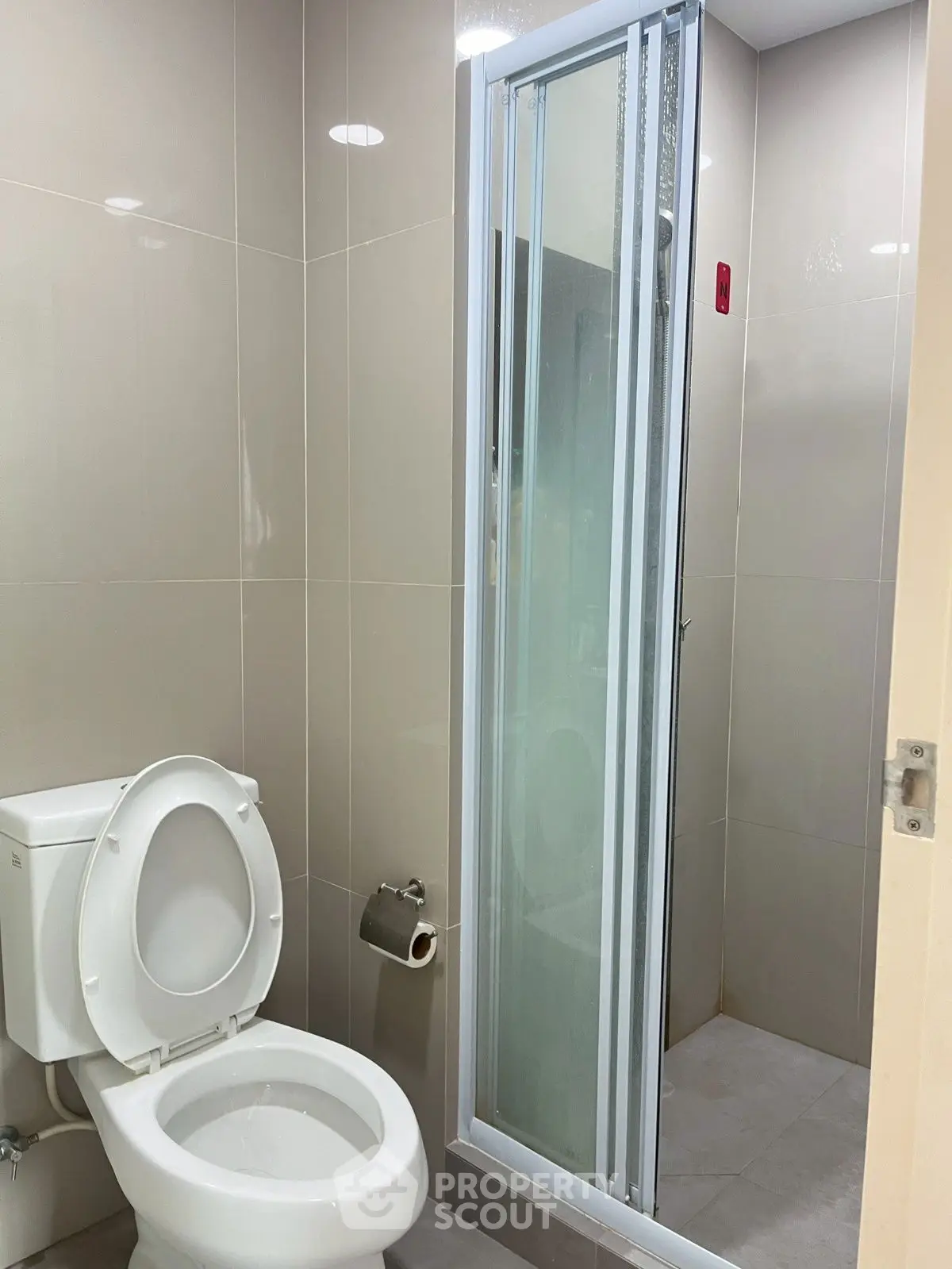 Modern bathroom with sleek shower and toilet in neutral tones
