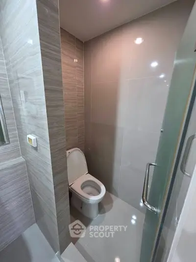 Modern bathroom with sleek tile design and contemporary toilet