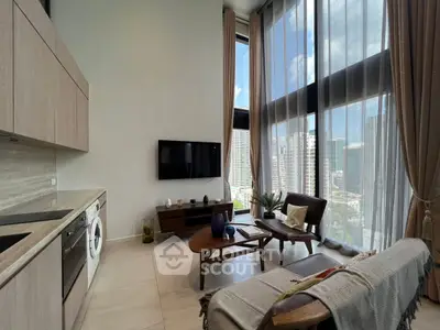 Modern living room with high ceilings and city view, featuring sleek kitchen and cozy seating area.