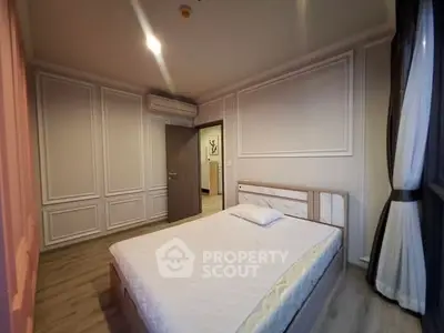 Spacious bedroom with elegant paneling and natural light