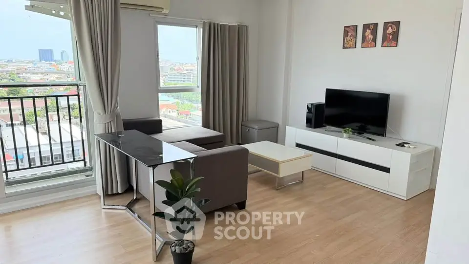 Modern living room with balcony view, stylish furniture, and natural light in urban apartment.