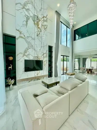 Luxurious modern living room with high ceilings and elegant marble accents