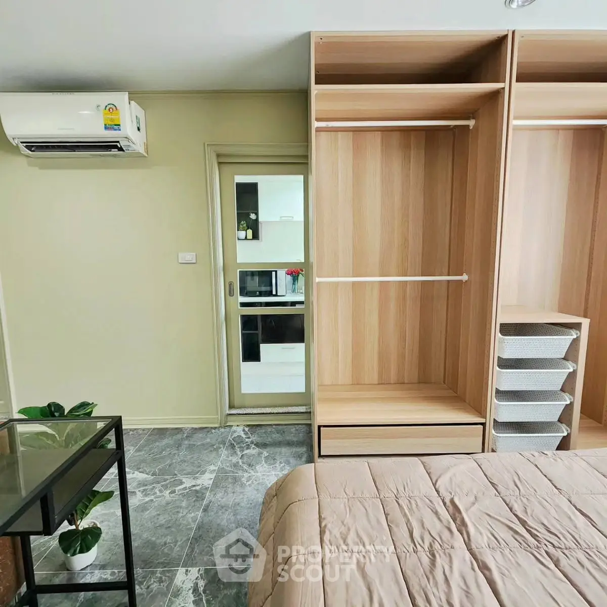 Modern bedroom with open wardrobe and air conditioning in a stylish apartment.