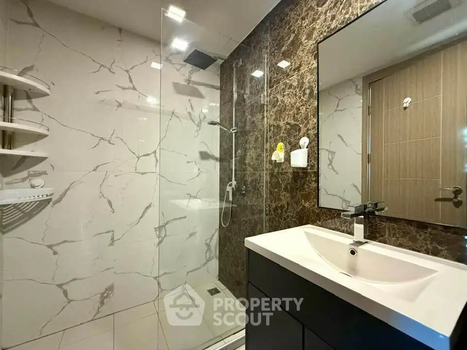 Modern bathroom with marble tiles and sleek fixtures