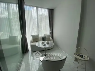 Modern minimalist living room with floor-to-ceiling windows and sleek furniture in a high-rise apartment.