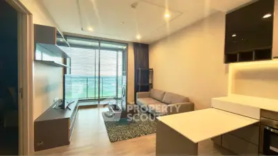 Modern living room with large windows and stylish furniture in a contemporary apartment.