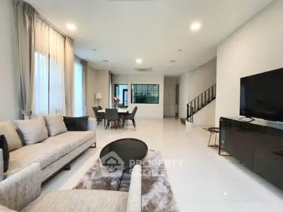 Spacious modern living room with elegant decor and open dining area.