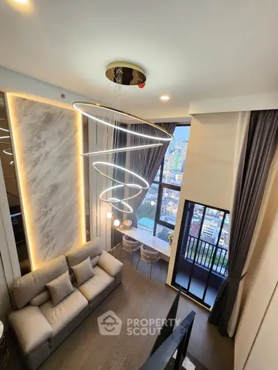 Stunning modern living room with spiral chandelier and city view balcony