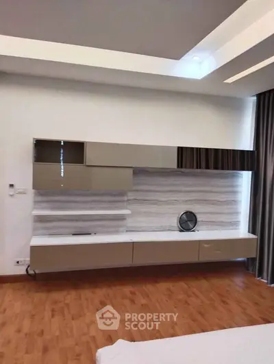 Modern living room with sleek wall-mounted storage and elegant wood flooring