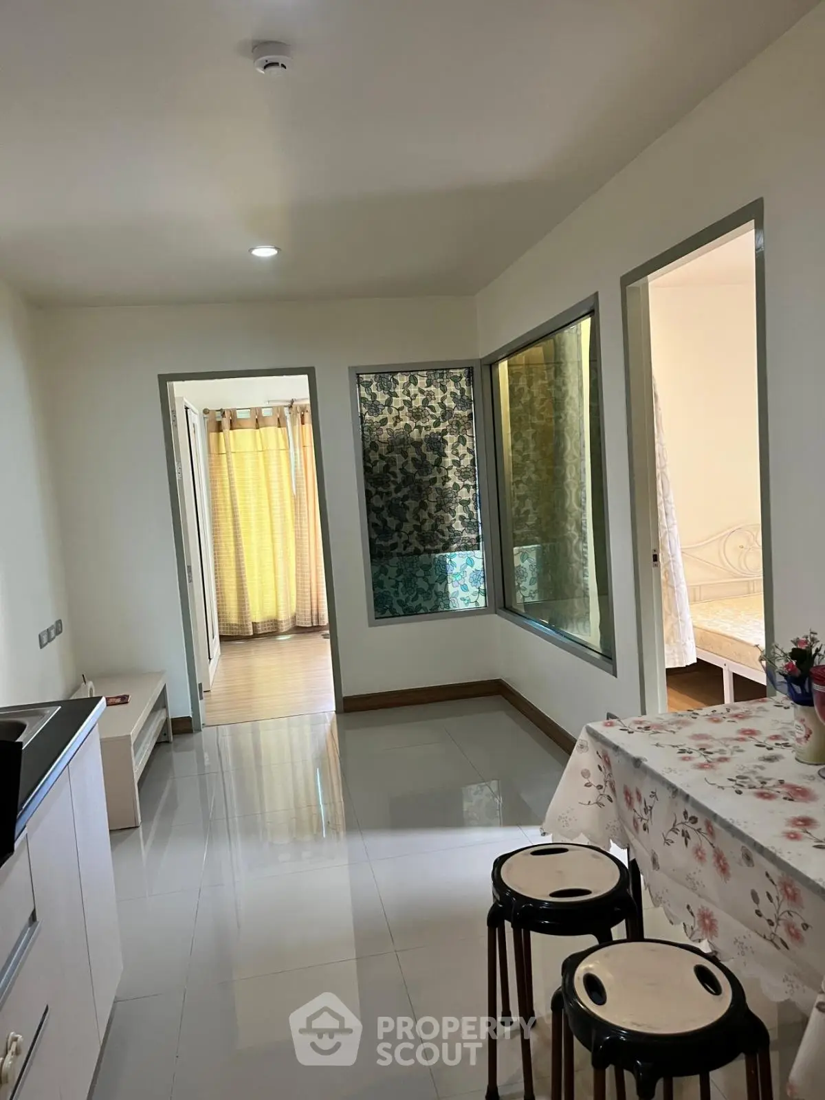 Charming apartment interior with modern kitchen and cozy dining area, perfect for urban living.