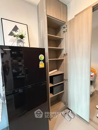 Modern kitchen with sleek black fridge and stylish wooden cabinetry