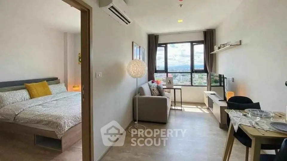 Modern studio apartment with panoramic city view, cozy living area, and stylish decor.