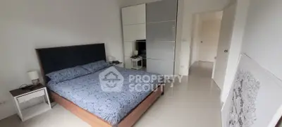 Modern bedroom with sleek design, featuring a comfortable bed and stylish wardrobe, perfect for relaxation.