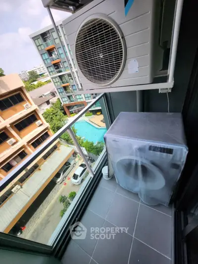 Modern balcony with pool view and air conditioning unit in urban setting