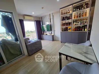 Modern living room with balcony and stylish bar cabinet in a high-rise apartment.