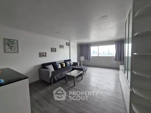Spacious modern living room with city view and stylish decor