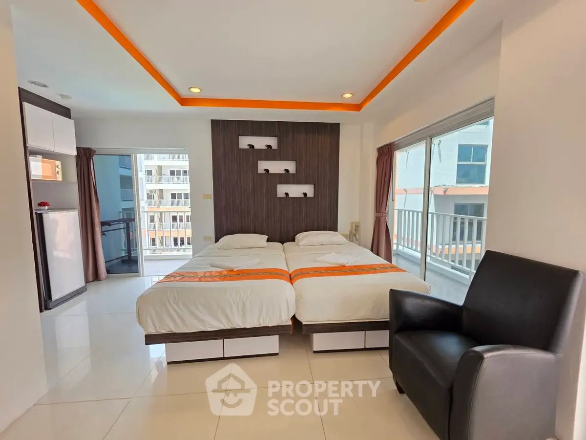 Modern bedroom with twin beds and balcony view in a stylish apartment