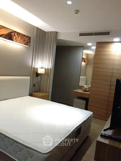 Modern bedroom with stylish wooden furniture and ambient lighting