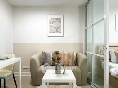 Modern living room with cozy sofa and stylish decor in a chic apartment.