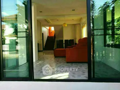 Spacious living room with modern design and large windows offering natural light.