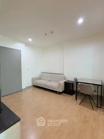 Modern living room with minimalist decor and wooden flooring