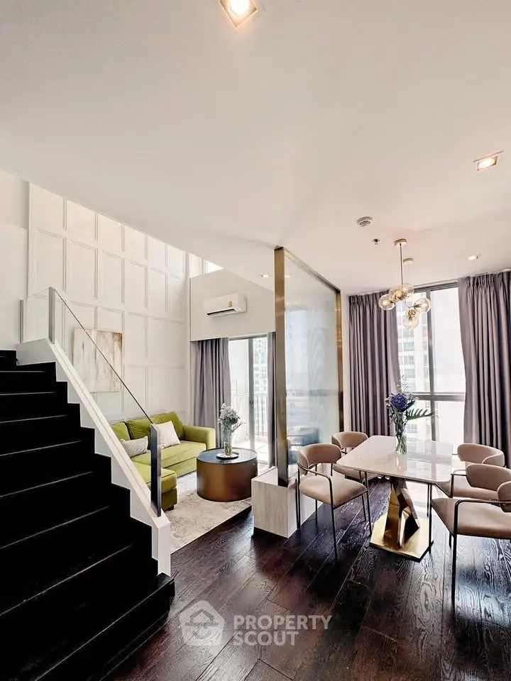 Luxurious modern living room with elegant dining area and stylish staircase in high-rise apartment.
