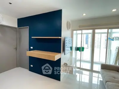 Modern living room with sleek design and balcony view in urban apartment.