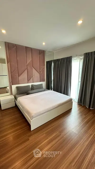Luxurious bedroom with elegant decor and large windows for natural light.