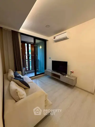 Modern living room with balcony access and sleek air conditioning unit