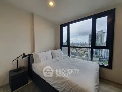 Modern bedroom with city view in high-rise apartment
