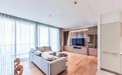 Spacious modern living room with large windows and elegant furnishings