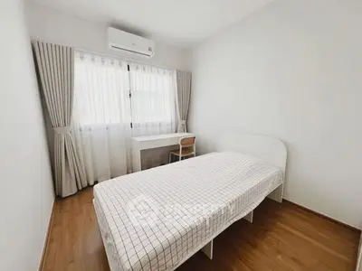 Cozy minimalist bedroom with single bed and study desk, perfect for a serene living experience.