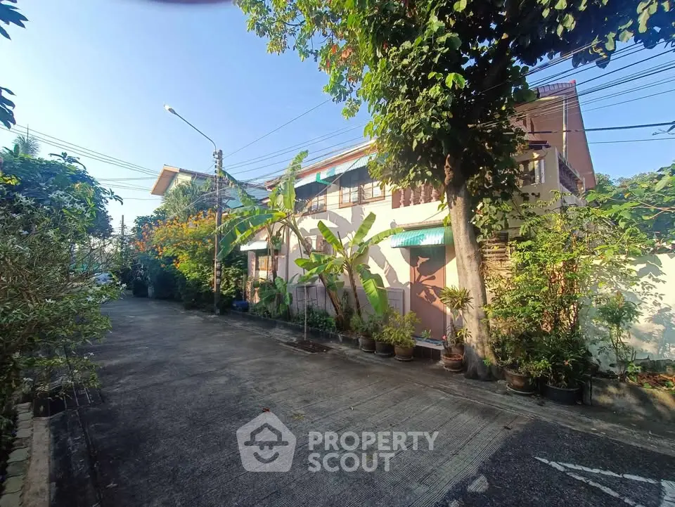 Charming residential street with lush greenery and cozy homes