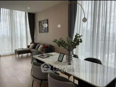 Elegant modern living room with floor-to-ceiling windows and stylish decor