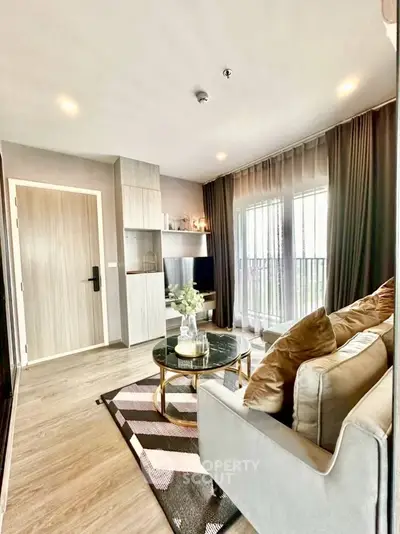 Modern living room with stylish decor and natural light in a contemporary apartment.