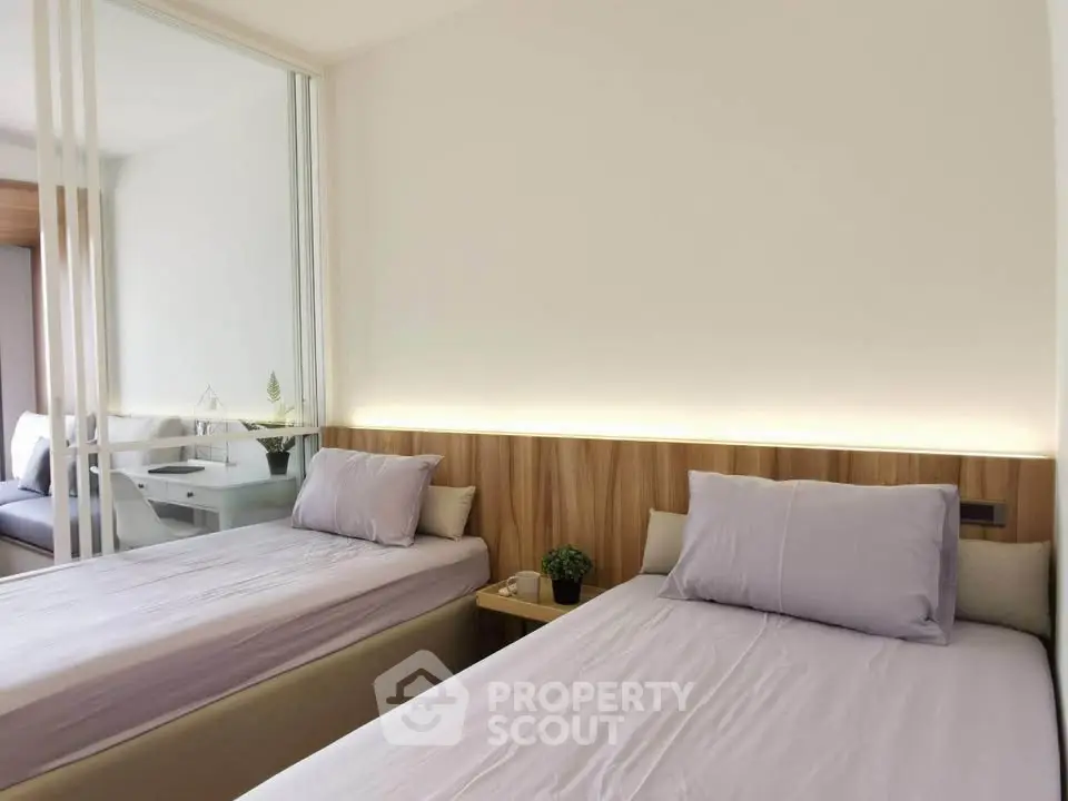 Modern bedroom with twin beds and mirrored closet in stylish apartment